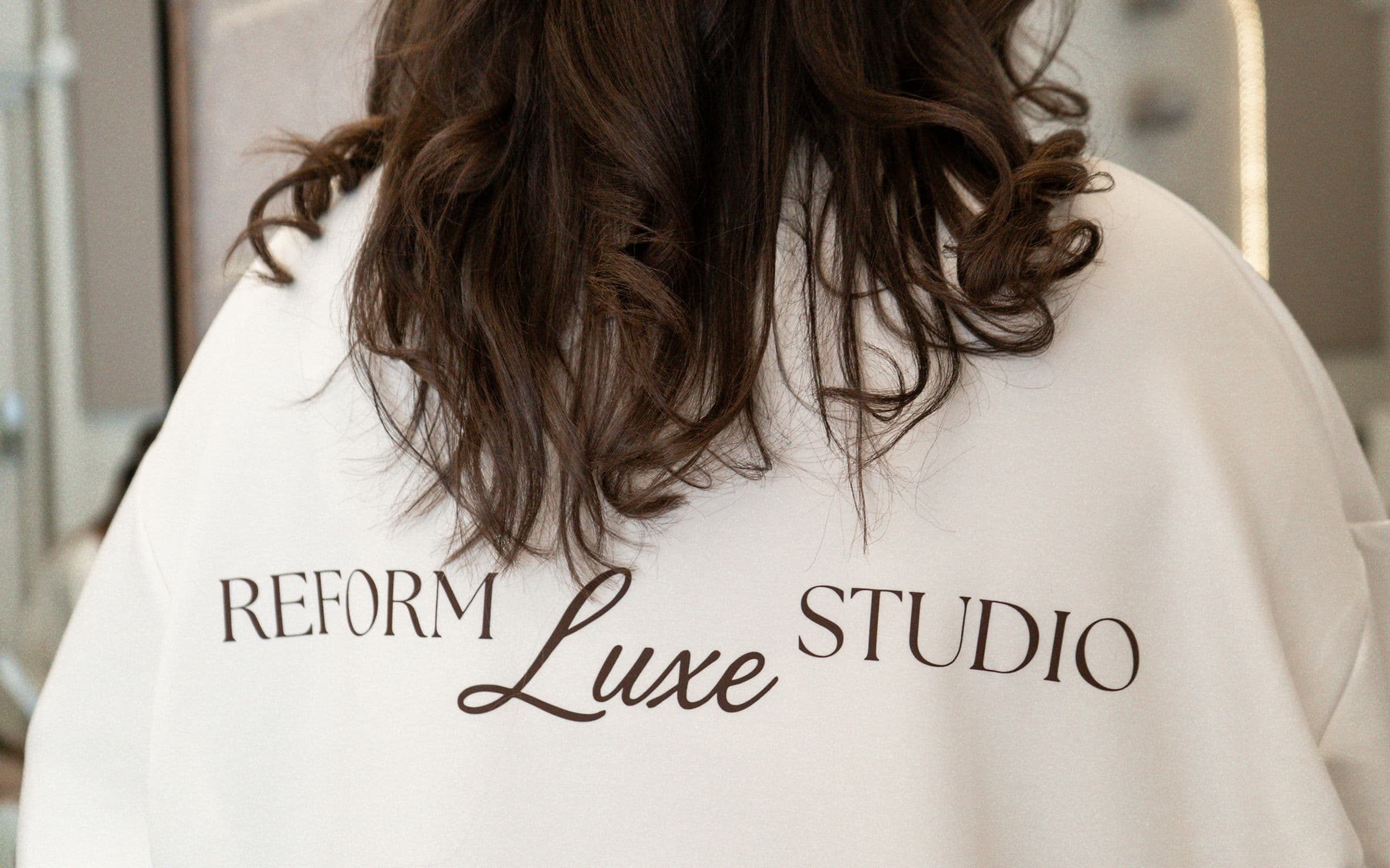 A member in a Reform Luxe Studio hoodie